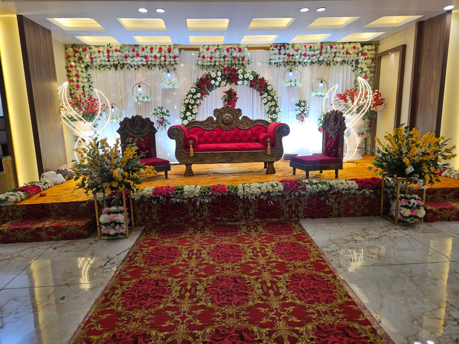 Decorated wedding mandap with floral arrangements at Hotel Veda Inn