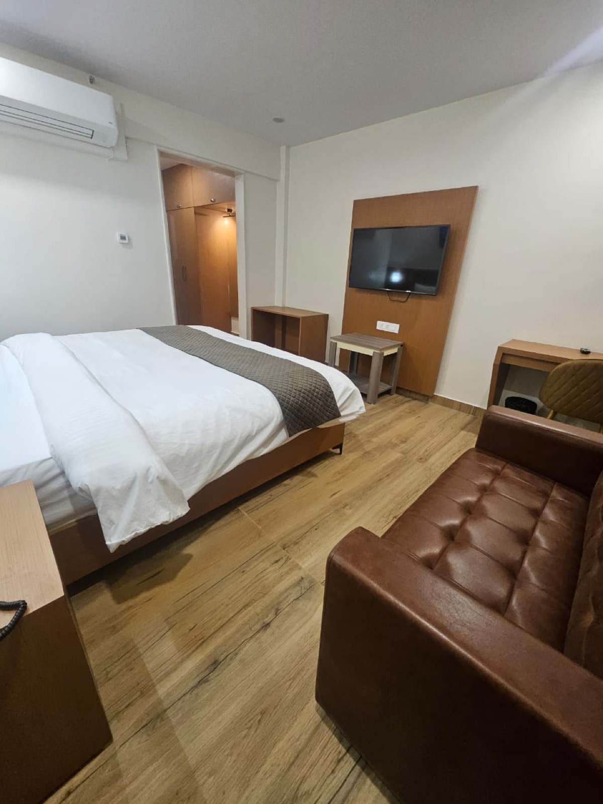 Bright, comfortable room interior at Hotel Veda Inn